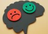 Com tantos tratamentos novos, por que o lítio ainda é referência no transtorno bipolar? cérebro com rosto feliz e rosto triste, representando o transtorno bipolar