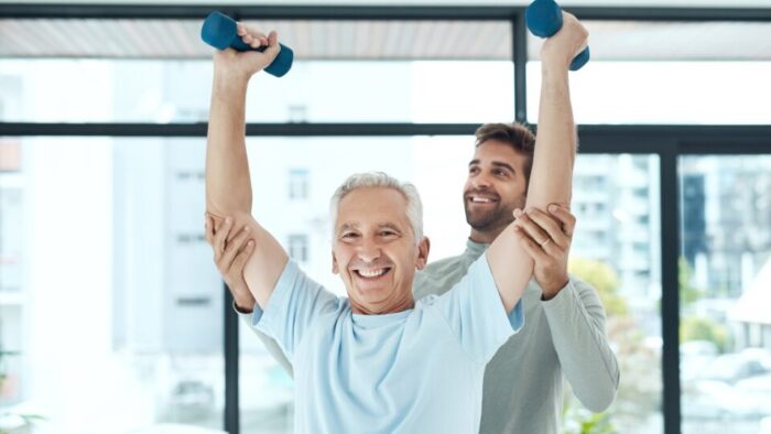 homem levantando halteres em treino de força orientado